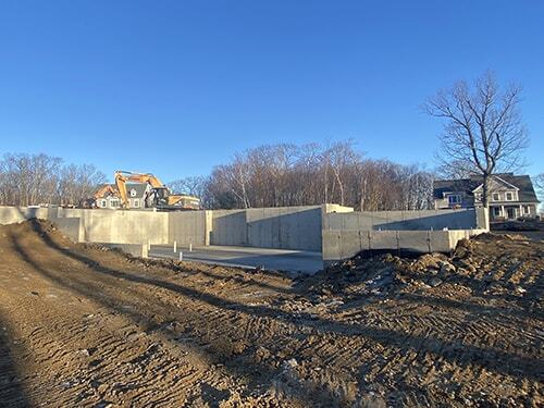 Excavator working next to house foundation in Great Barrington, MA