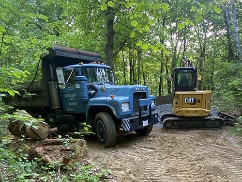 Excavator and dump truck operated by East Hill Earthworks Excavator and dump truck operated by East Hill Earthworks